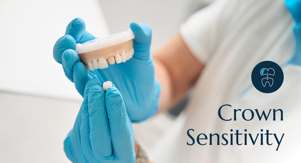 A dental professional holding a pari of fake teeth showing how a dental crown works.